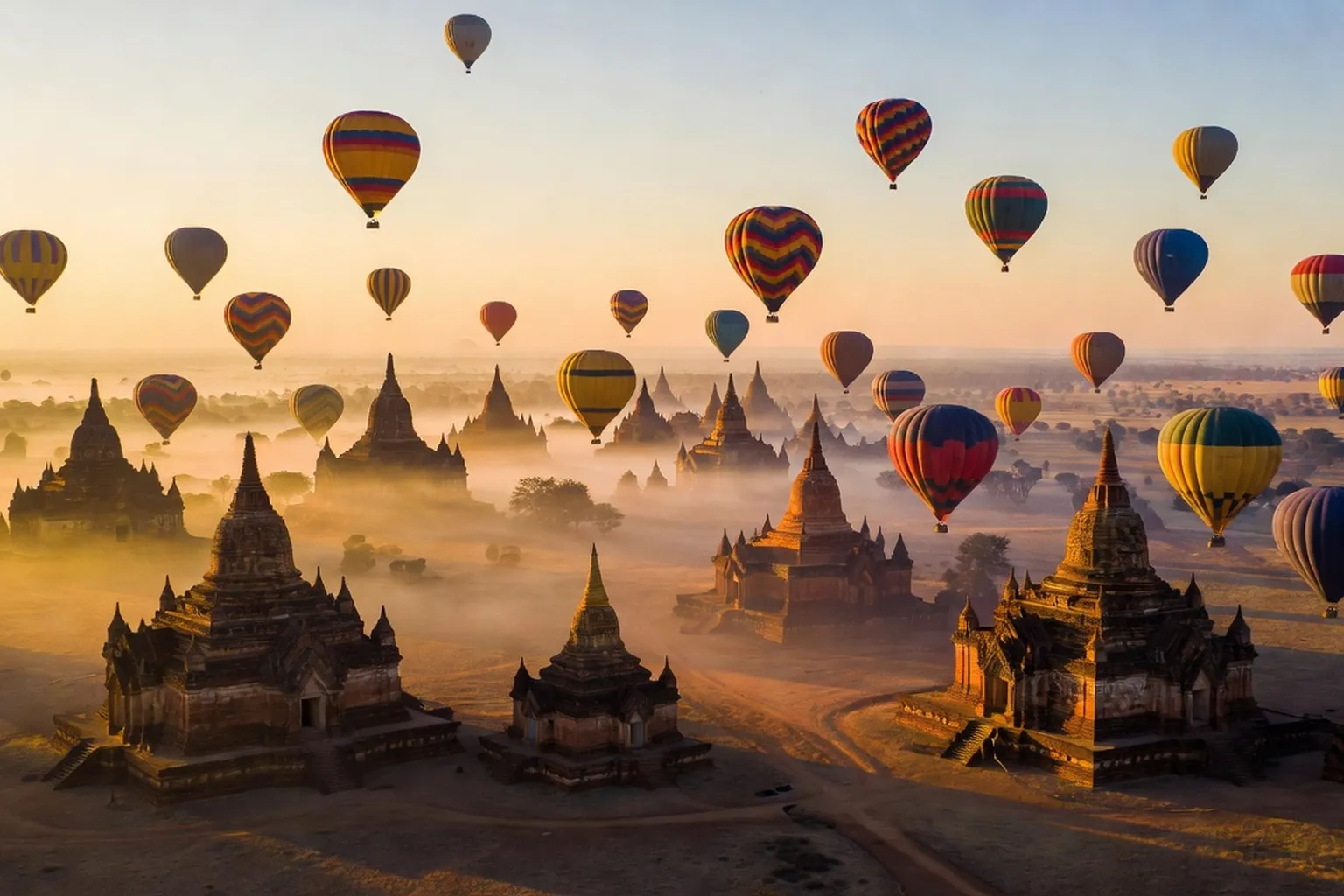 Temples de Bagan en Birmanie au lever du soleil avec montgolfieres dans le ciel